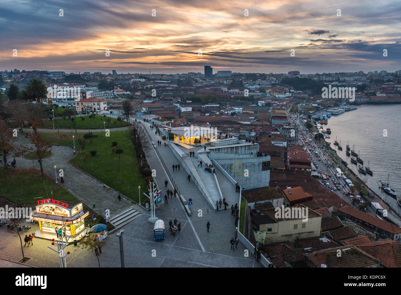 Sunset over Vila Nova de Gaia city. View with food booth with Portuguese doughnuts called Farturas Stock Photo