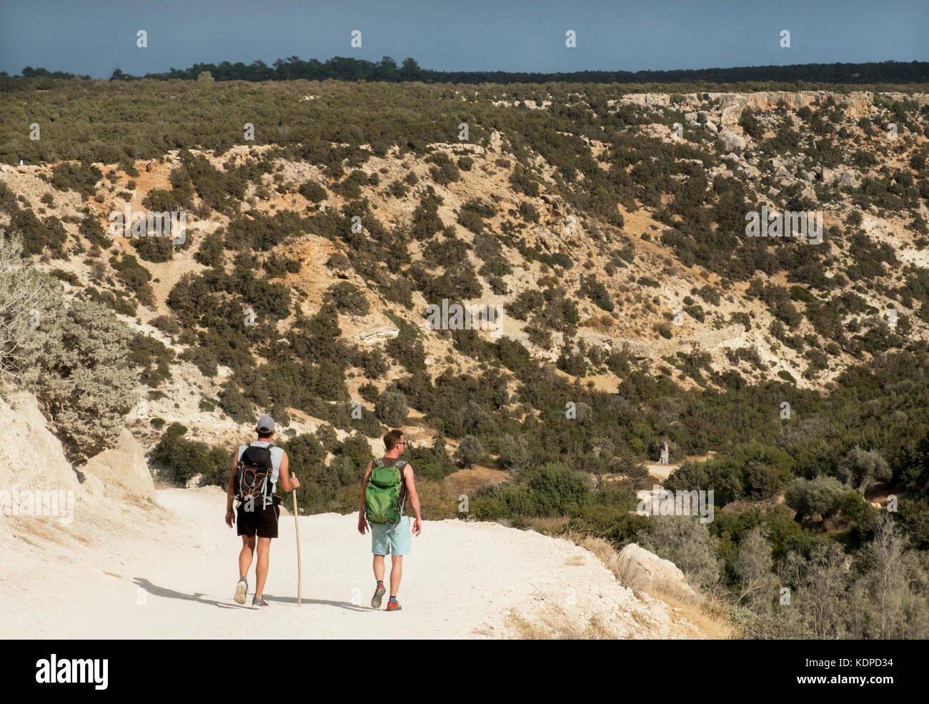 Two walkers on the access road to the Avakas Gorge on the Akamas peninsula, Peyia district, Paphos, Cyprus. Stock Photo