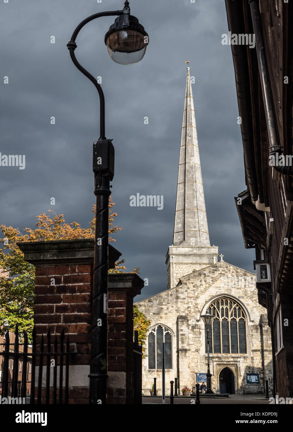 St Michael's Church in sunlight with Tudor House on right. Southampton, England, UK. Stock Photo