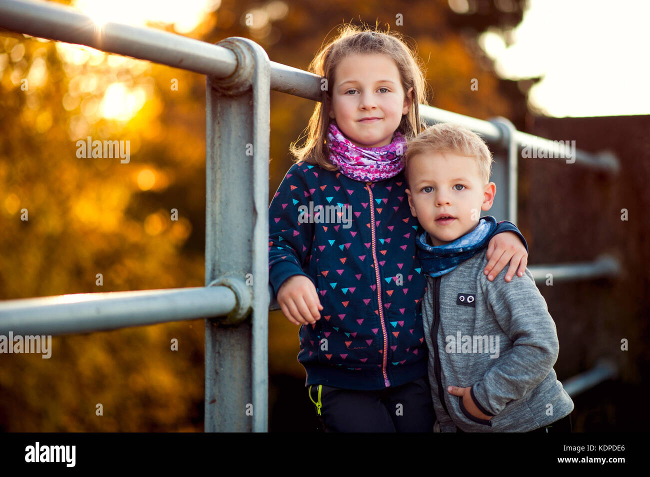 siblings enjoying nice colourful autumn Stock Photo - Alamy