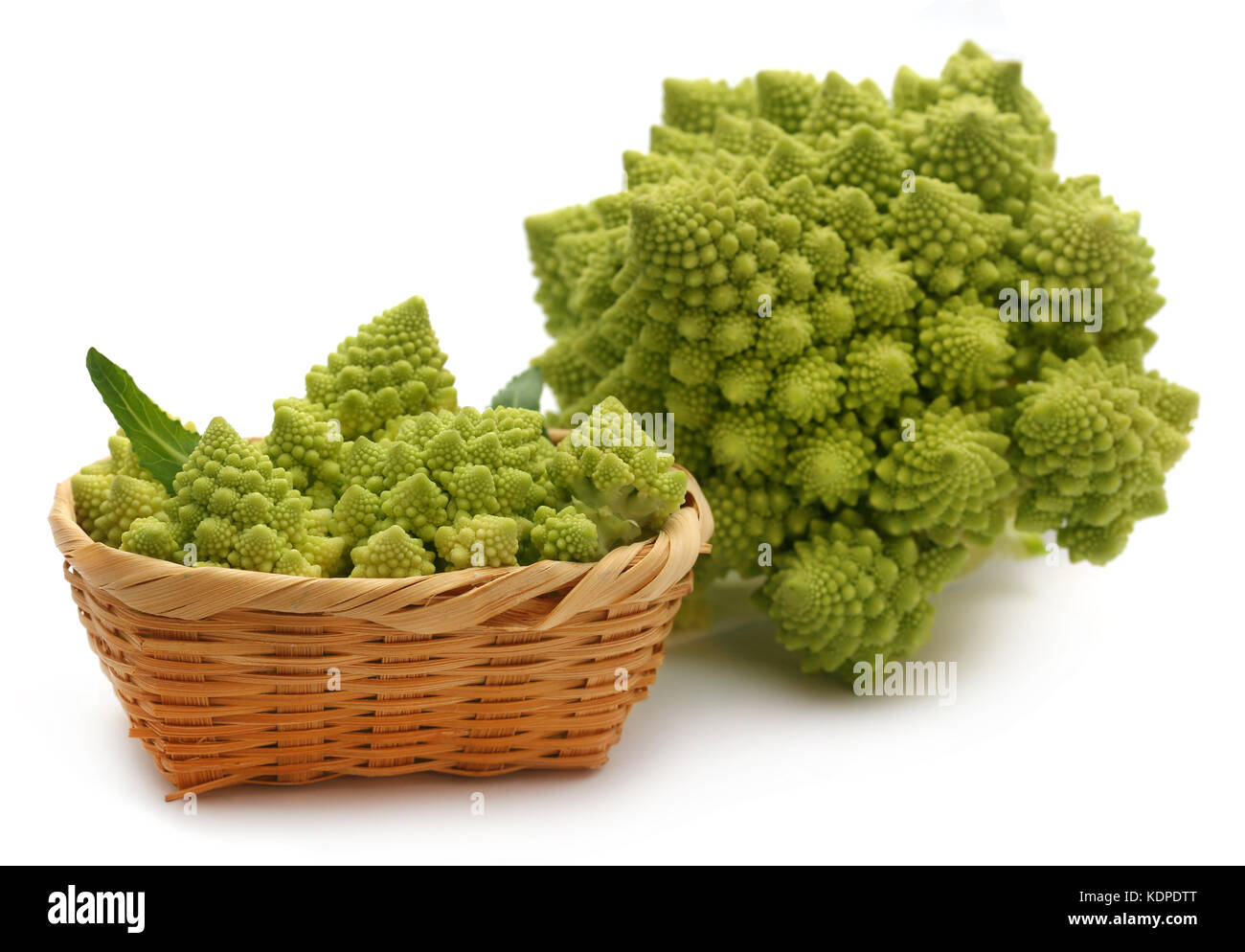 Romanesco broccoli in a basket over white background Stock Photo