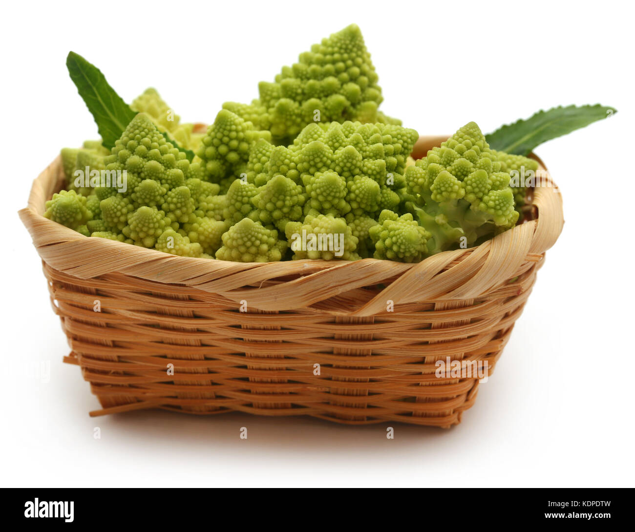 Romanesco broccoli in a basket over white background Stock Photo