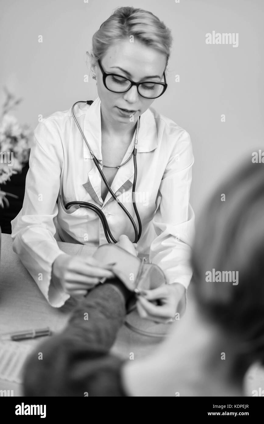 Doctor measures pressure in the office Stock Photo