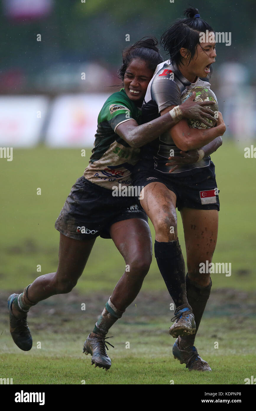 Colombo, Sri Lanka. 15th Oct, 2017. Player of Singapore is tackled by Player of  Sri Lanka  during the Asia Rugby Women's Sevens 2017 match between Sri Lanka and Singapore at Race Course Ground on 15 October 2017 in Colombo, Sri Lanka.  Credit: Lahiru Harshana/Alamy Live News Stock Photo