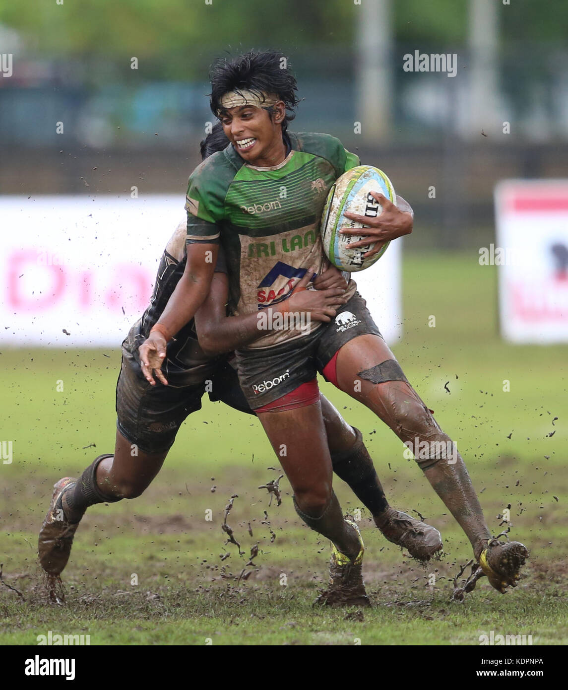 Colombo, Sri Lanka. 15th Oct, 2017. Player of Sri Lanka is tackled by Player of  Singapore during the Asia Rugby Women's Sevens 2017 match between Sri Lanka and Singapore at Race Course Ground on 15 October 2017 in Colombo, Sri Lanka.  Credit: Lahiru Harshana/Alamy Live News Stock Photo