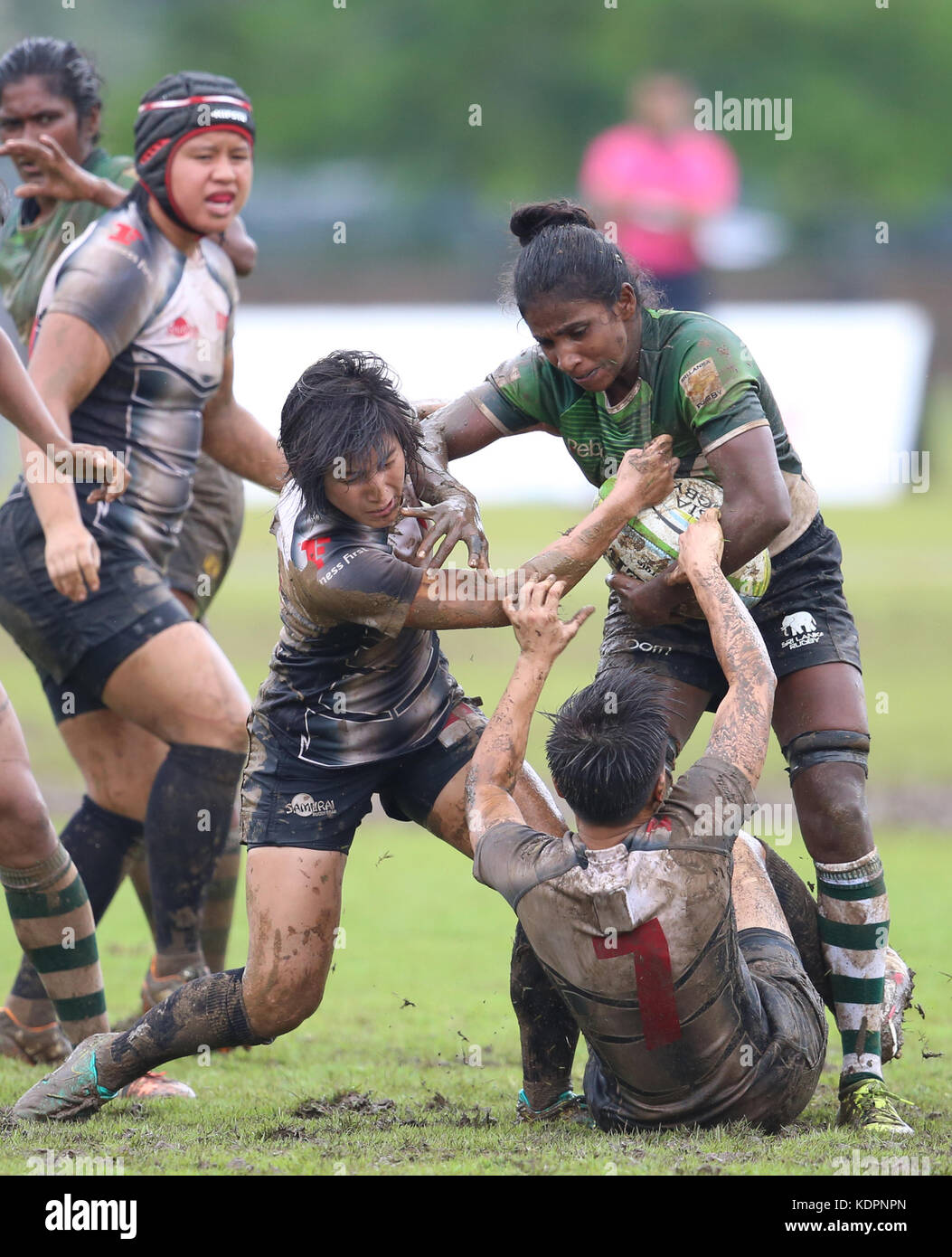 Colombo, Sri Lanka. 15th Oct, 2017. Player of Sri Lanka is tackled by Player,s of  Singapore during the Asia Rugby Women's Sevens 2017 match between Sri Lanka and Singapore at Race Course Ground on 15 October 2017 in Colombo, Sri Lanka.  Credit: Lahiru Harshana/Alamy Live News Stock Photo