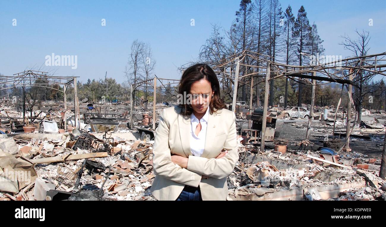 U.S. Sen. Kamala Harris walks through the remains of homes destroyed by wild fires sweeping across Sonoma County October 14, 2017 in Santa Rosa, California. Stock Photo