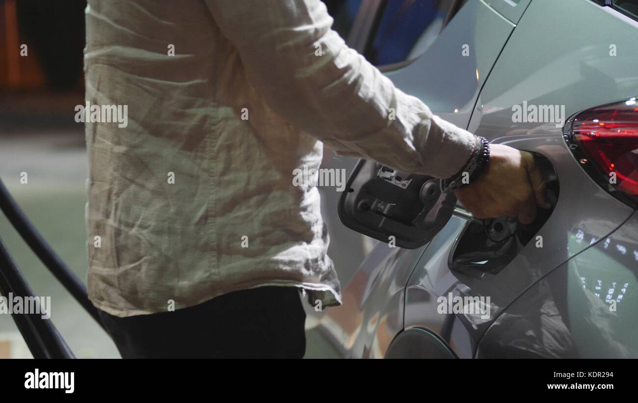 Young man fueling his car at gas station Stock Photo