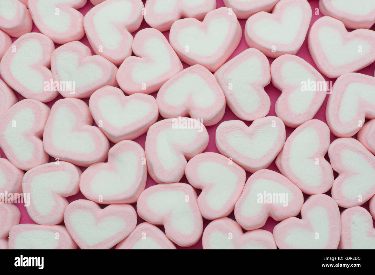 Pink heart shaped marshmallows background Stock Photo - Alamy