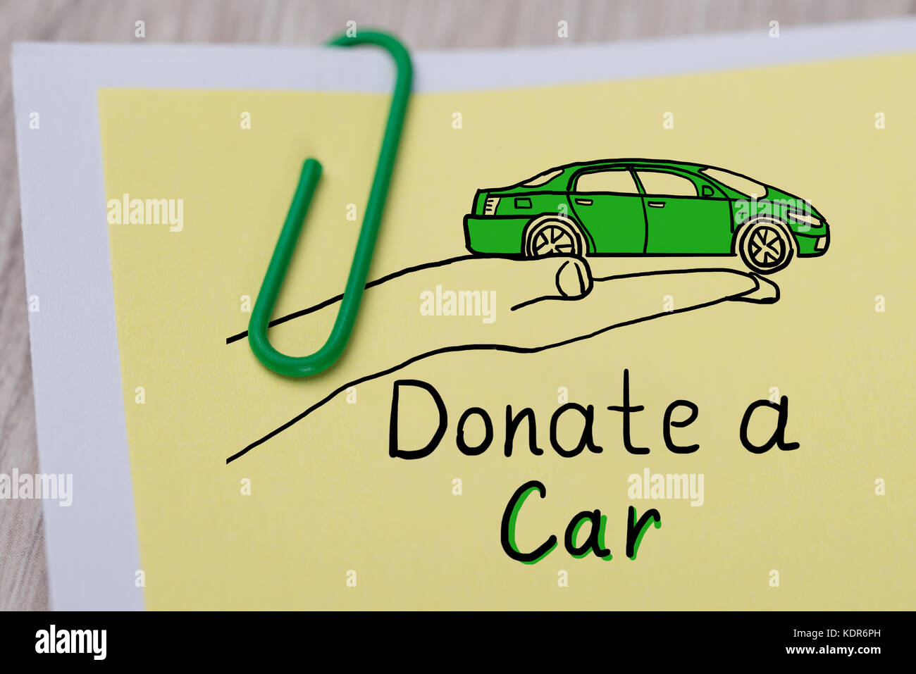 Close-up Of Concept Of Car Donation Text Written On Note Paper Attached With Paper Clip Stock Photo
