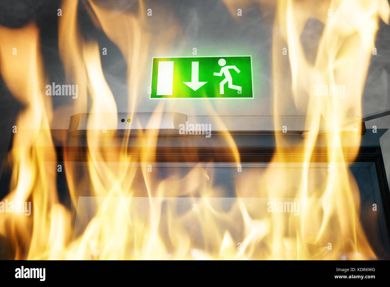 Close-up Of Fire Burning Near An Emergency Exit Door Of The Building Stock Photo