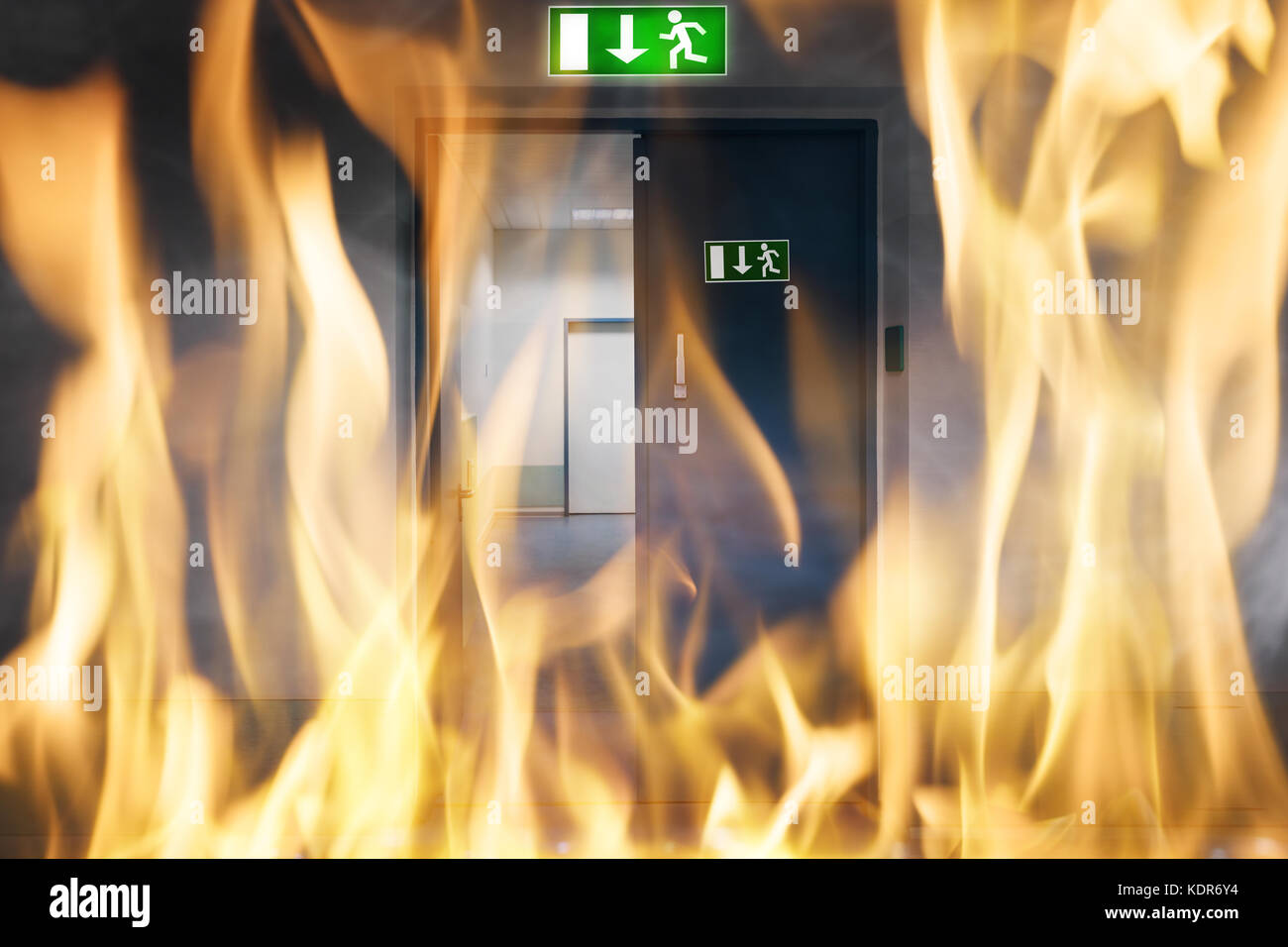 Close-up Of Fire Burning Near An Emergency Exit Door Of The Building Stock Photo