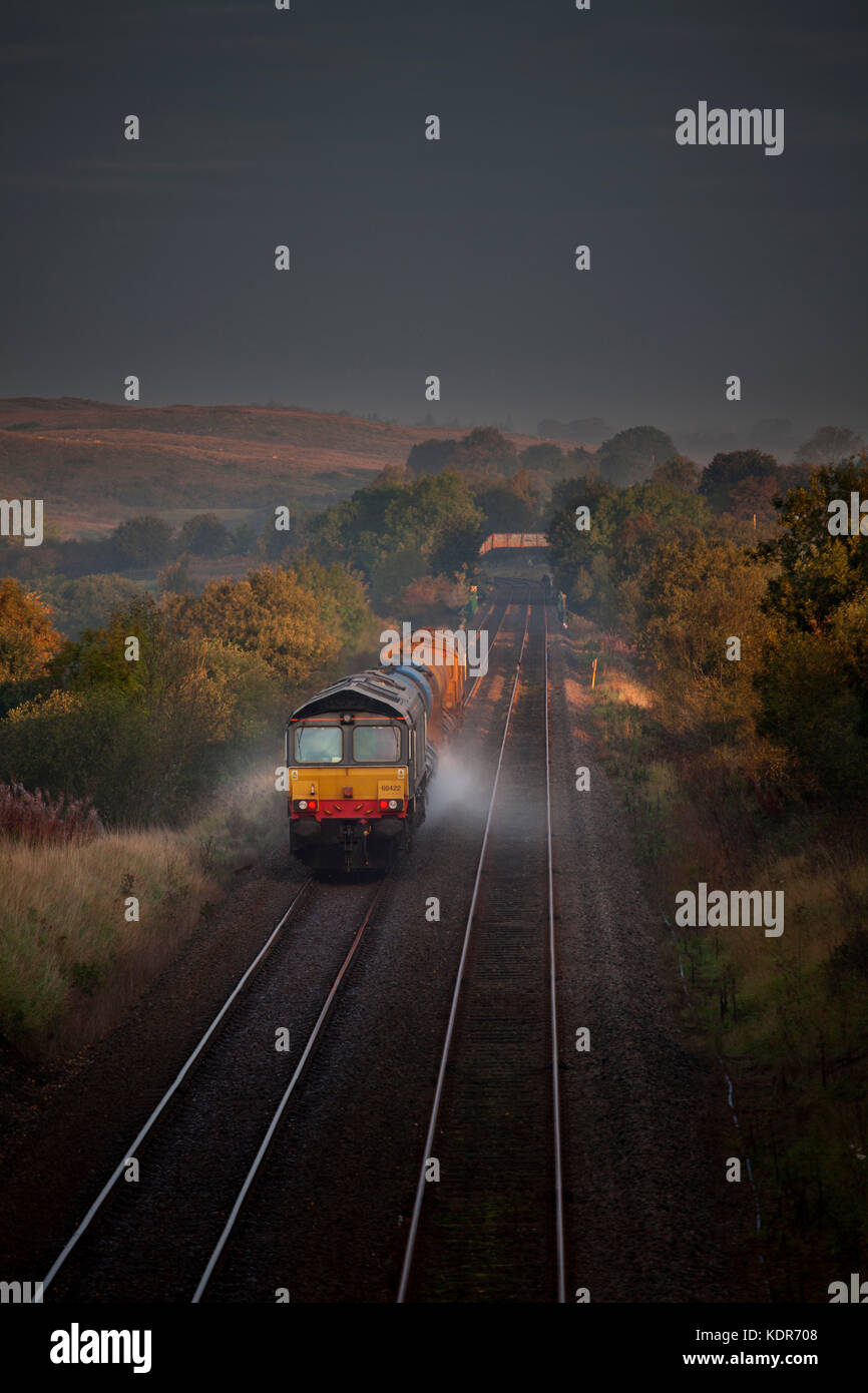 A Network rail Railhead treatment train, washing the leaves from the railhead passes Clapham (Yorkshire)  hauled by Direct rail Services class 66's Stock Photo