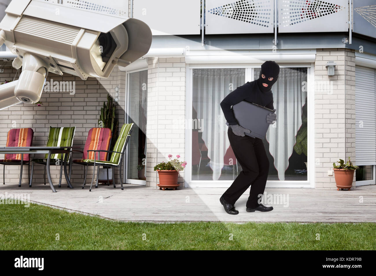 Security Camera Capturing Thief Wearing Balaclava Running With Laptop