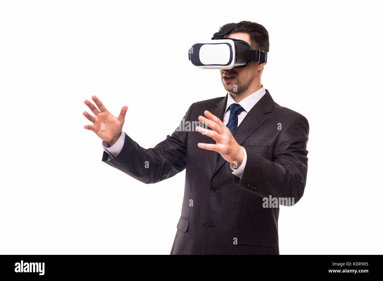 Young handsome businessman in black suit wearing virtual reality ...