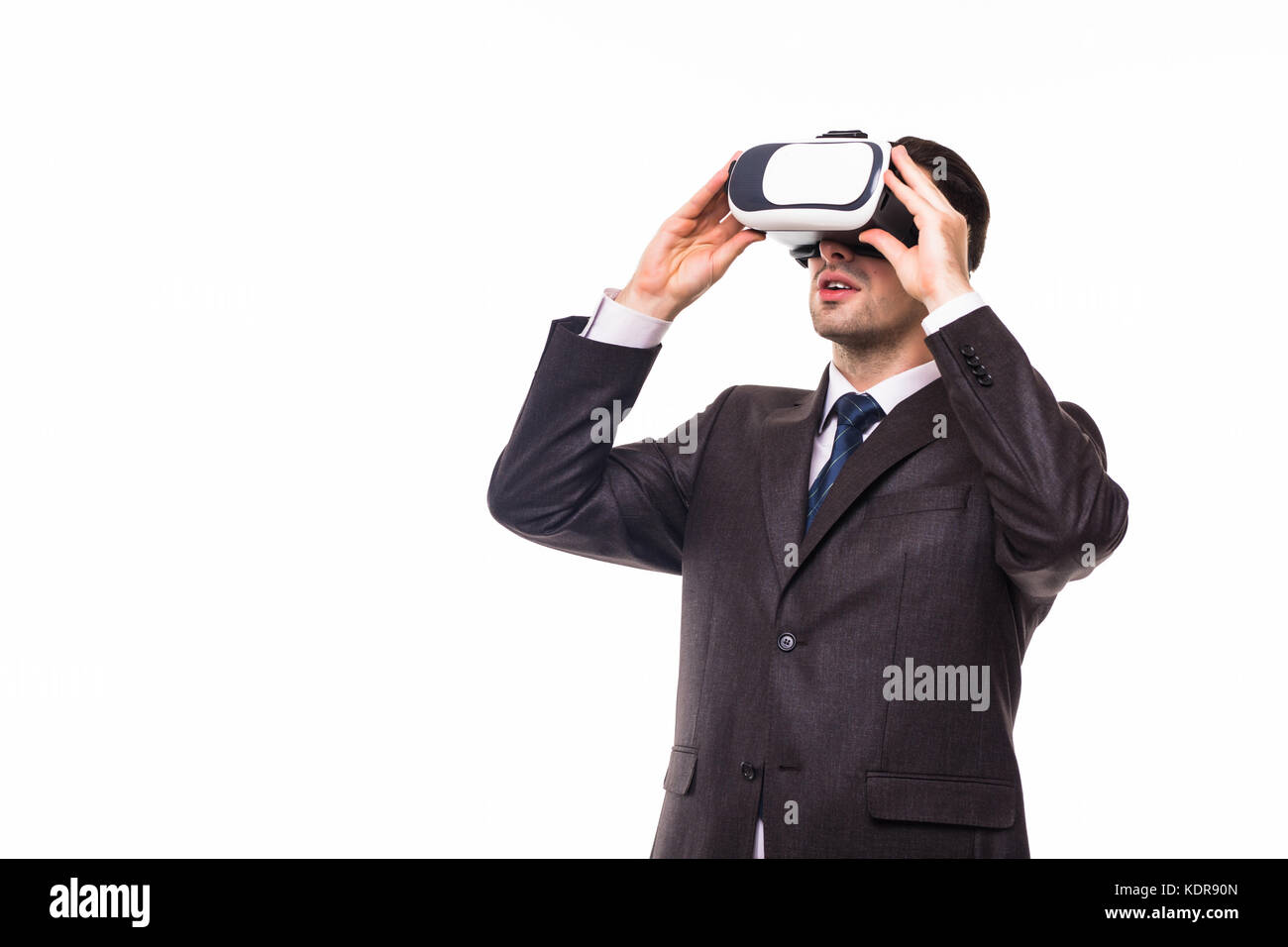 Young handsome businessman in black suit wearing virtual reality ...