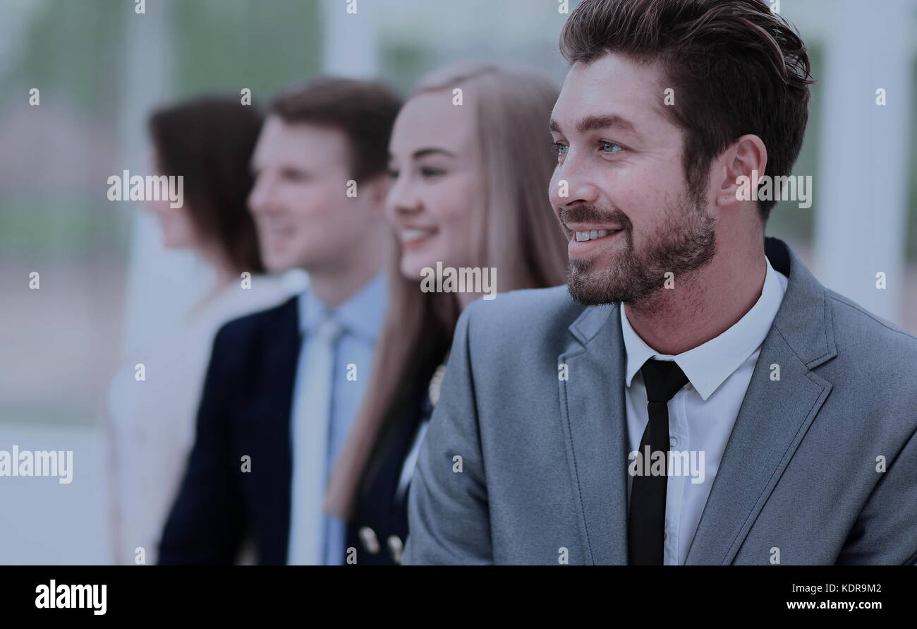 group of business people smiling in an office lined up Stock Photo - Alamy