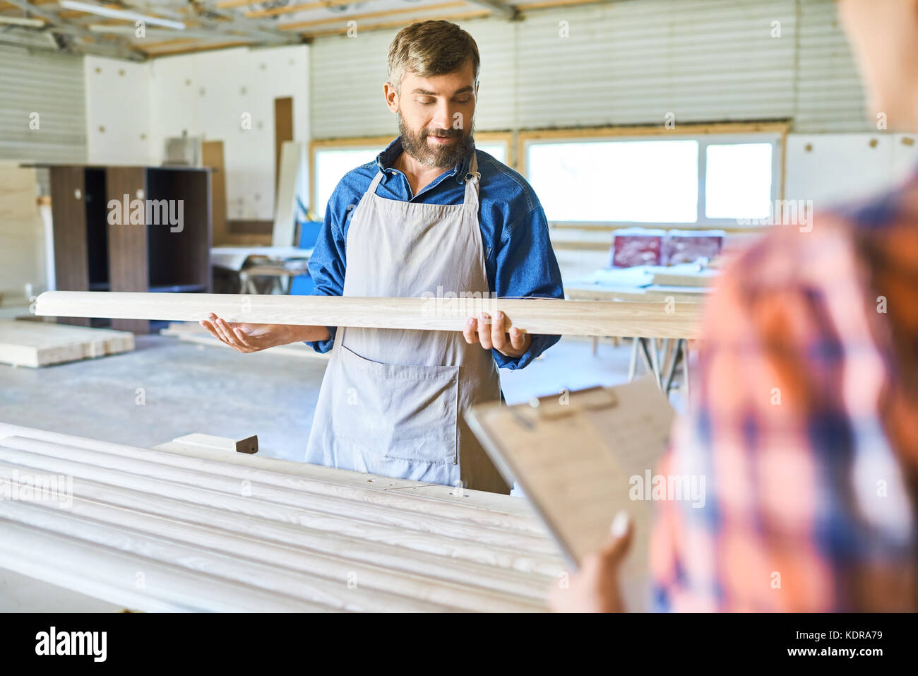 Skilled Carpenter Choosing Wood Material Stock Photo