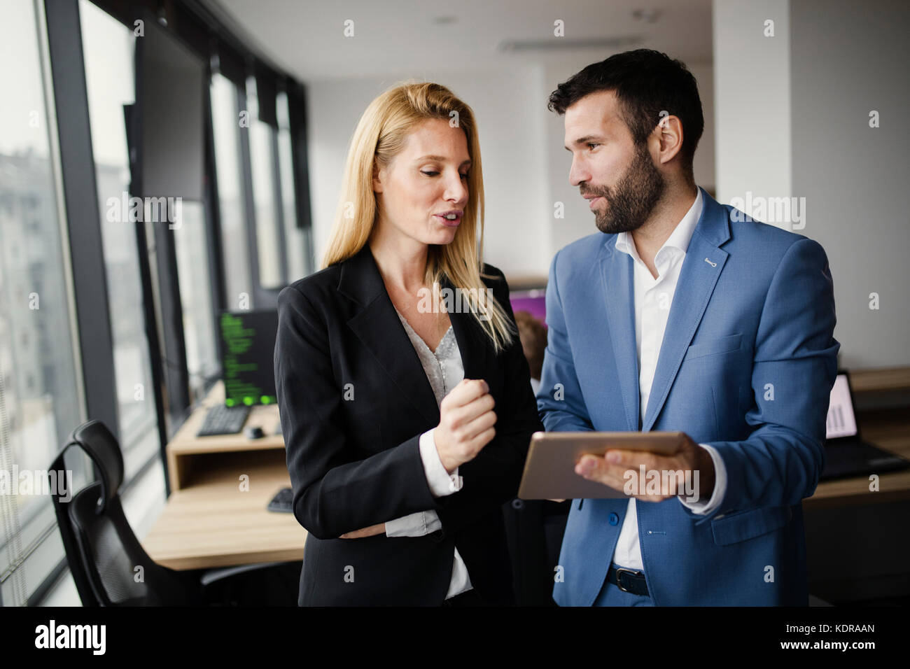 Portrait of attractive business partners using tablet Stock Photo