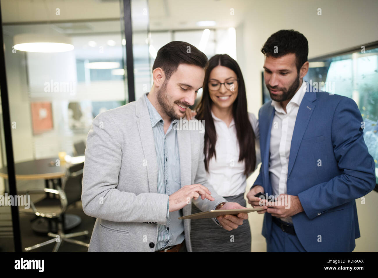 Team of colleagues working together on tablet Stock Photo