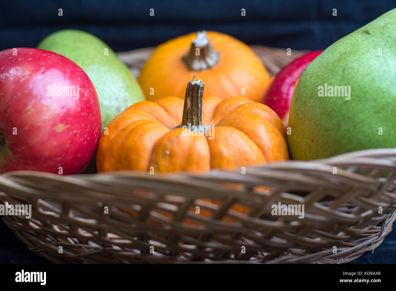 fall harvest of apples,pears and pumpkins in a wicker basket Stock ...