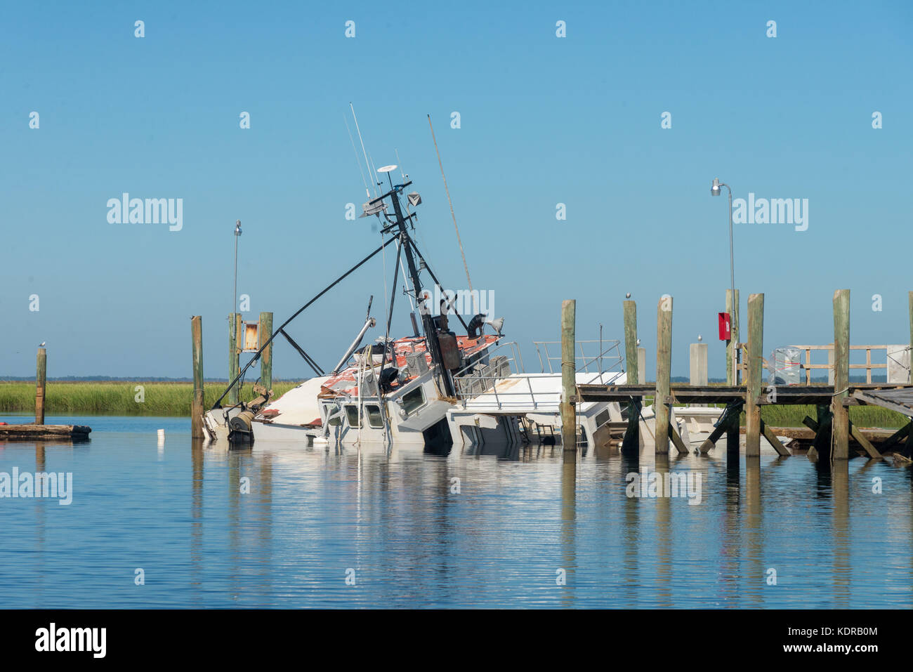 Wrecked boats are pushed up against a dock in the aftermath of