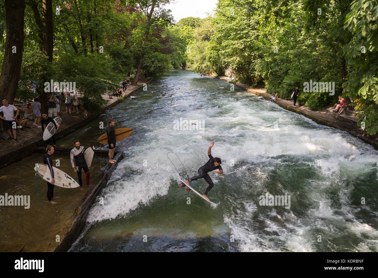 Surfer surfing an artificial wave in Munich city center, Germany. Stock Photo