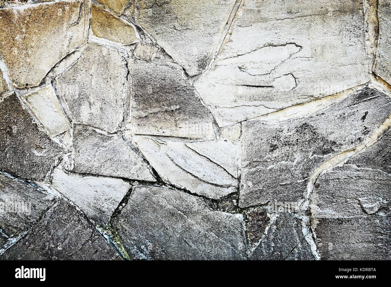 Fragmented Stone Fragment of the ancient stone wall executed from stones of various form ...