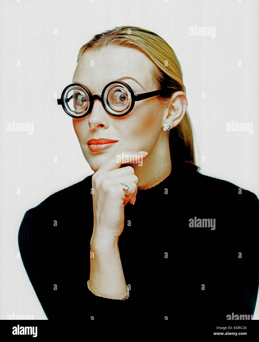 Young woman. Studio portrait. Thick lense spectacles. Stock Photo