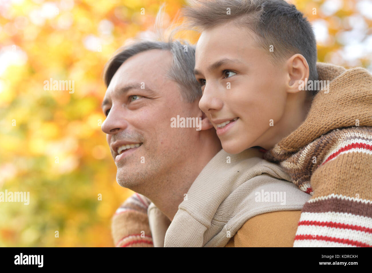 Father and son in autumn park Stock Photo - Alamy