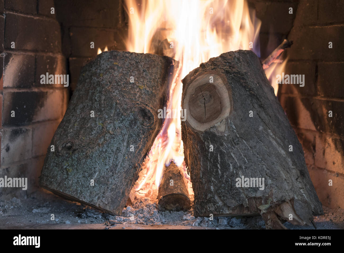 Large logs burn in the fireplace Stock Photo Alamy