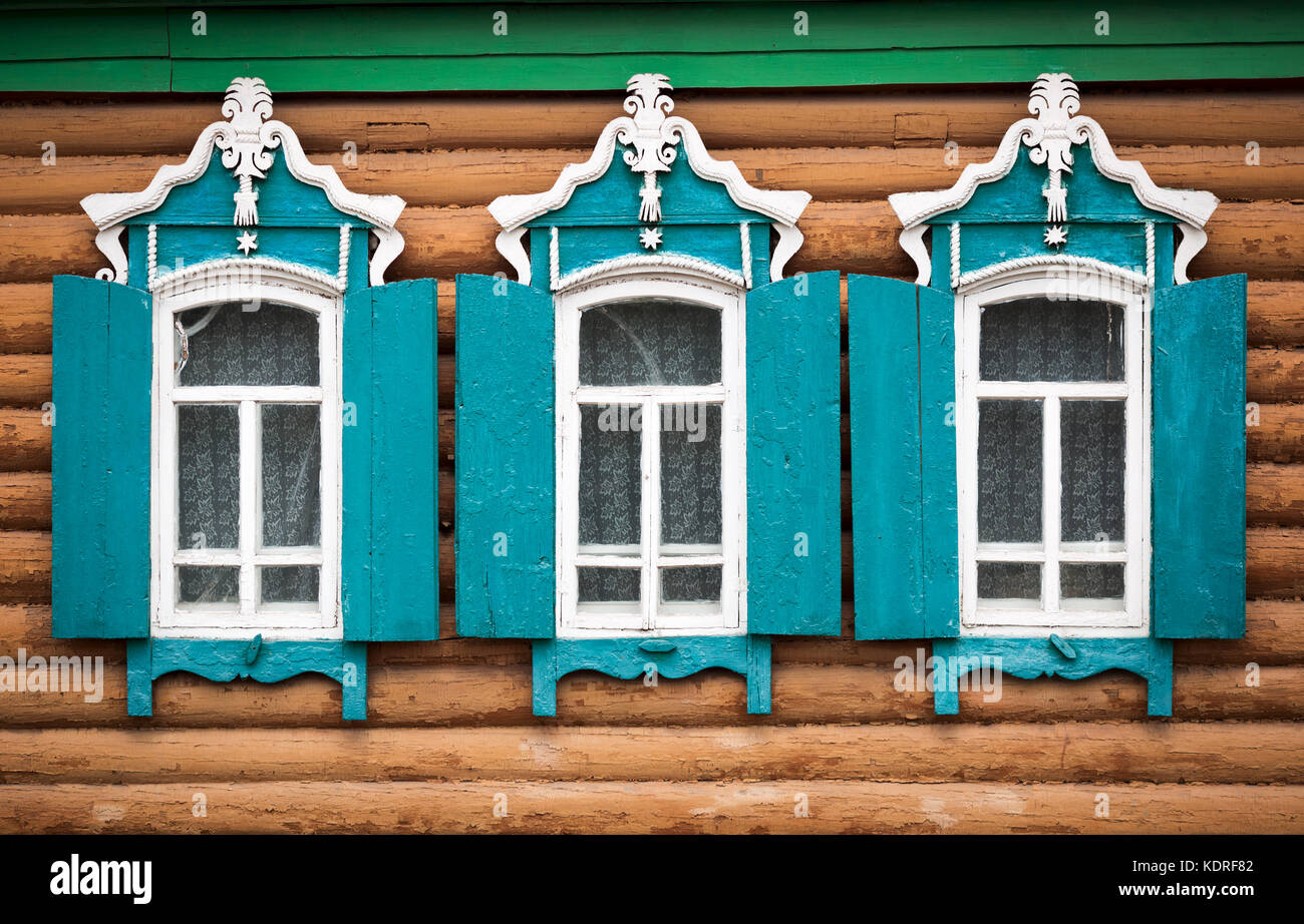 three windows with shutters Stock Photo - Alamy