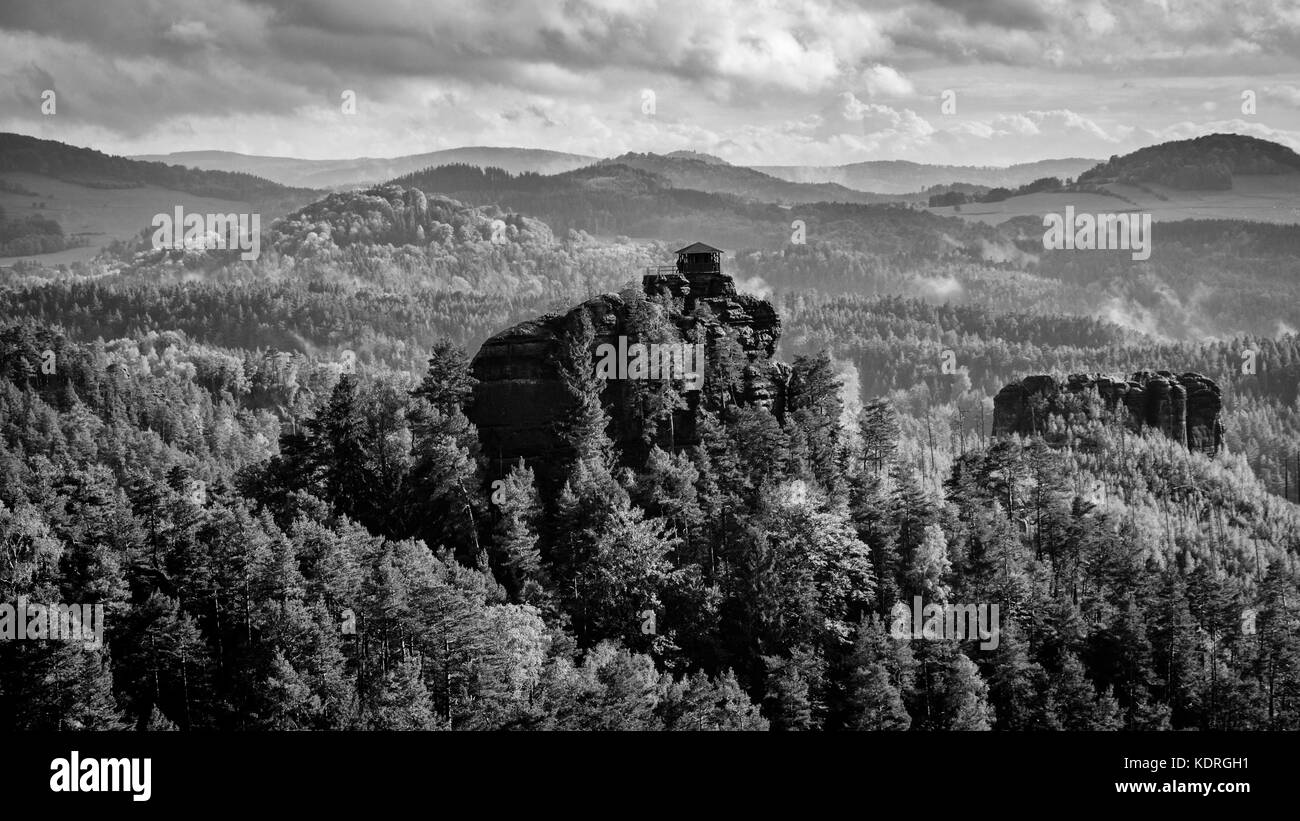 Black and white picture of the sun breaking through after a storm on an autumn afternoon over Jetrichovice, beautiful landscape, Bohemian Switzerland, Stock Photo