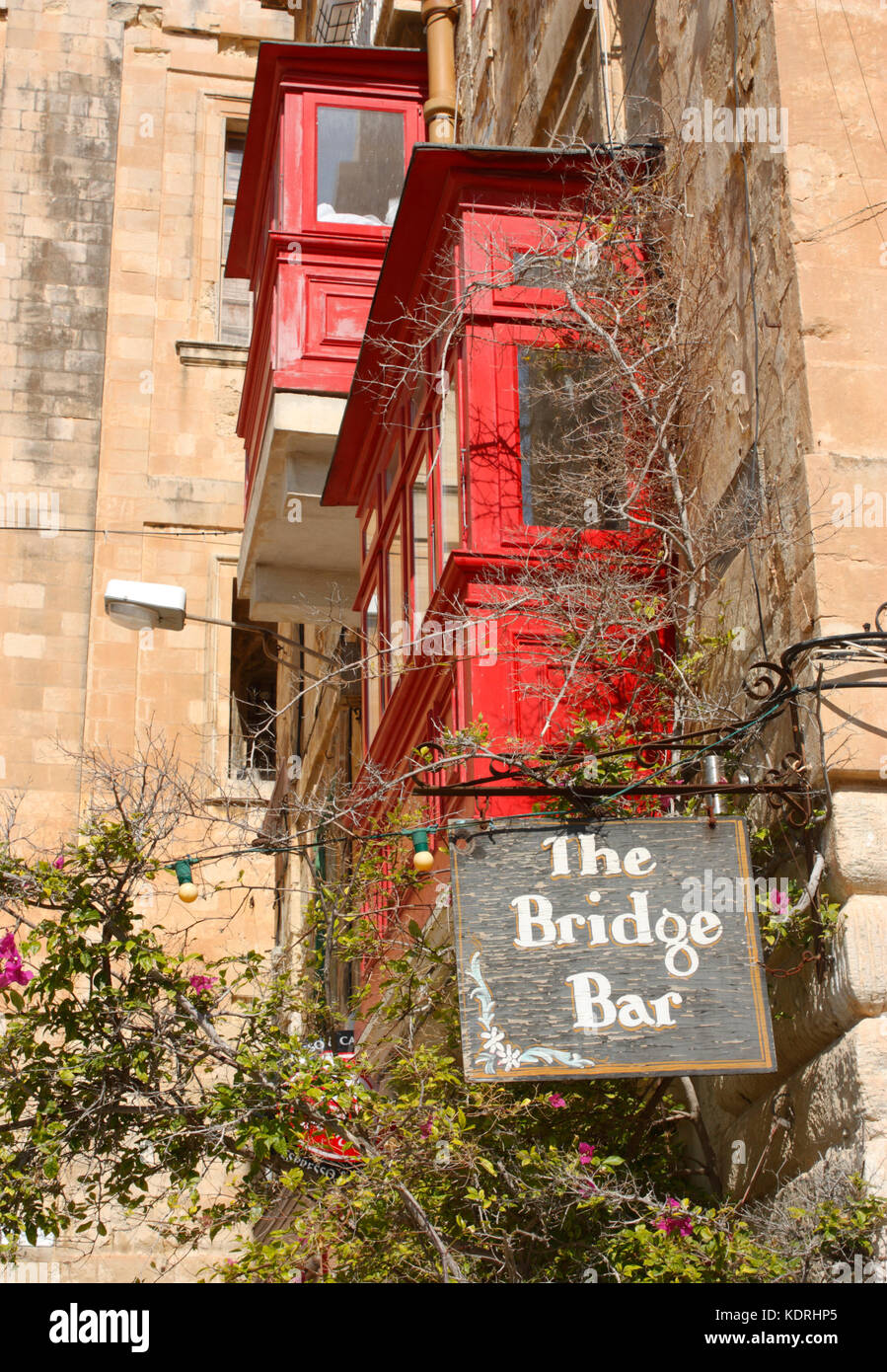 Sign of the Bridge Bar, St Ursula Street, Valletta, with two red balconies in the background Stock Photo