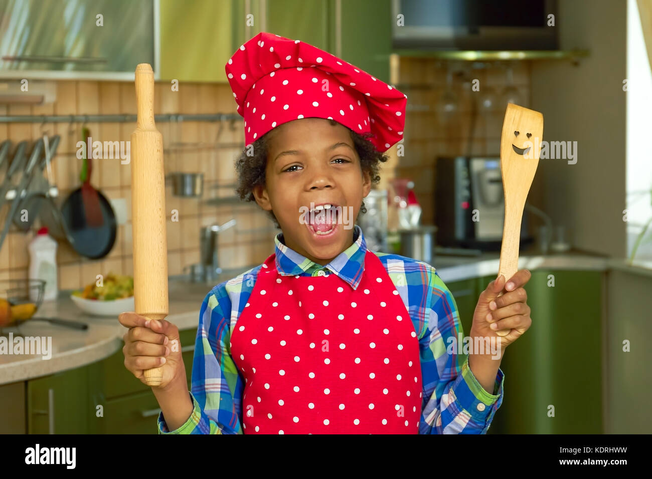 Black kid with cooking utensils Stock Photo Alamy