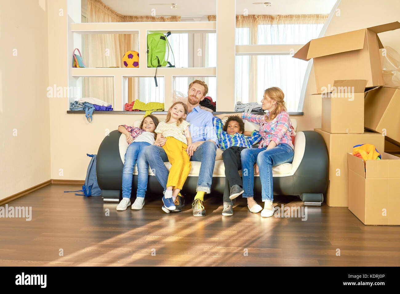 Family relaxing after relocation Stock Photo - Alamy