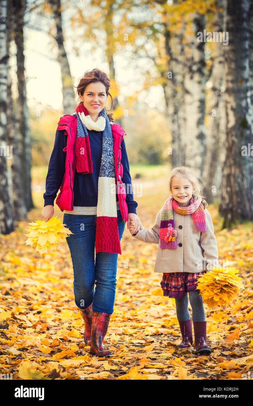 Mother and daughter in the autumn park Stock Photo - Alamy
