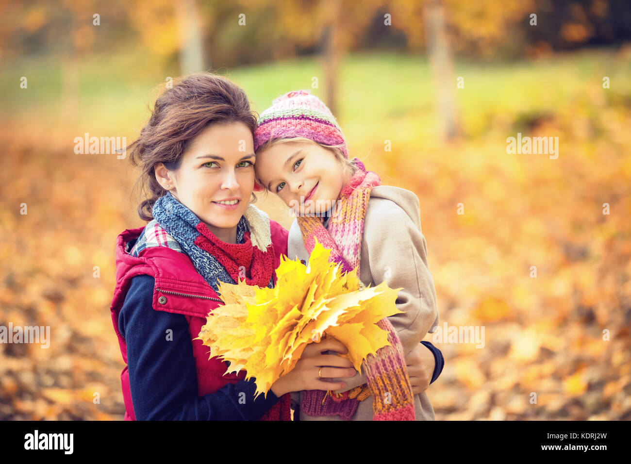 Mother and daughter in the autumn park Stock Photo - Alamy