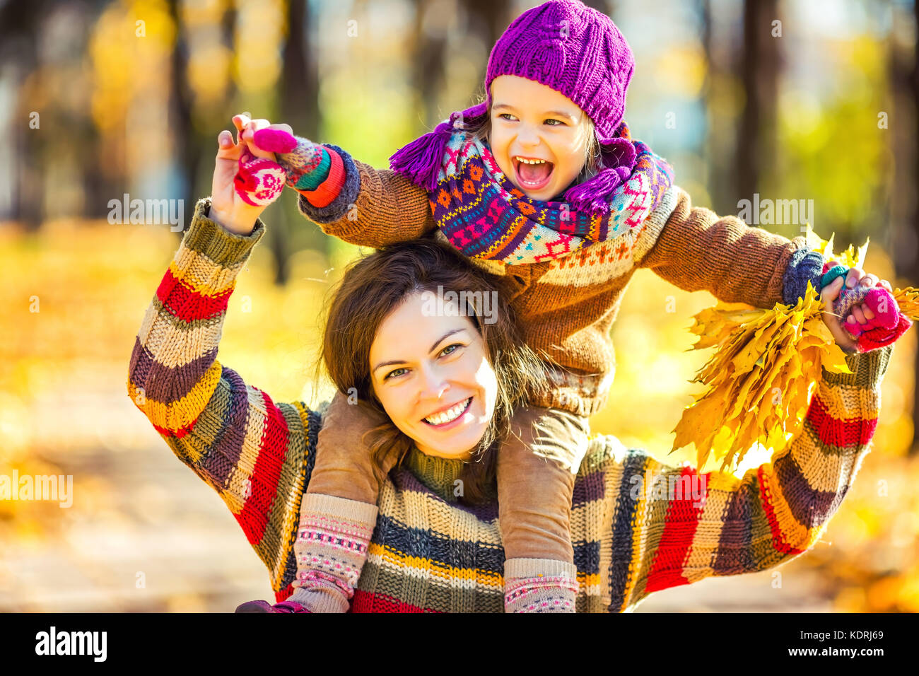 Mother and daughter playing in autumn park Stock Photo - Alamy