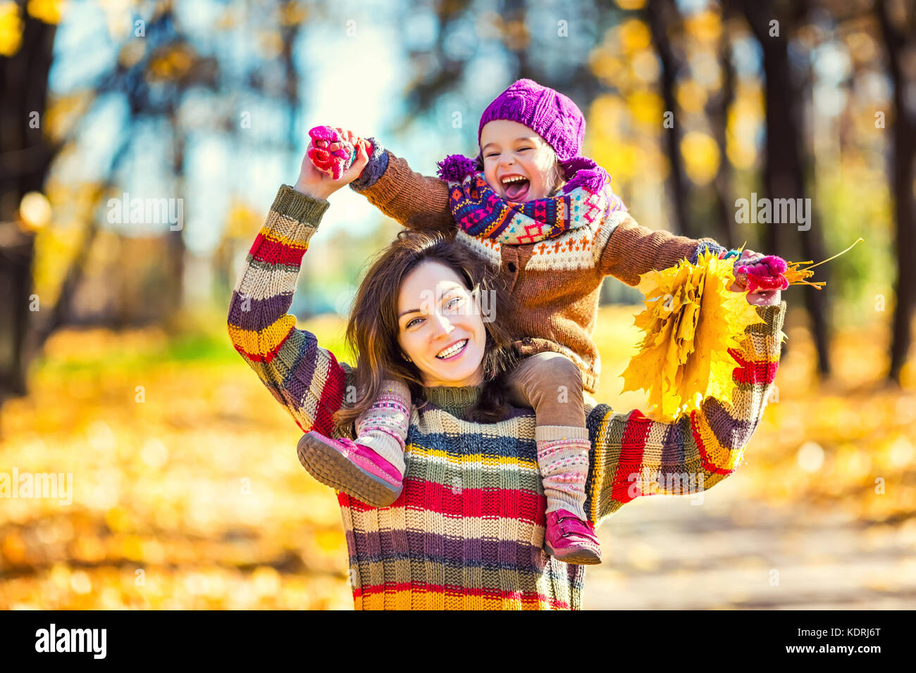 Mother and daughter playing in autumn park Stock Photo - Alamy