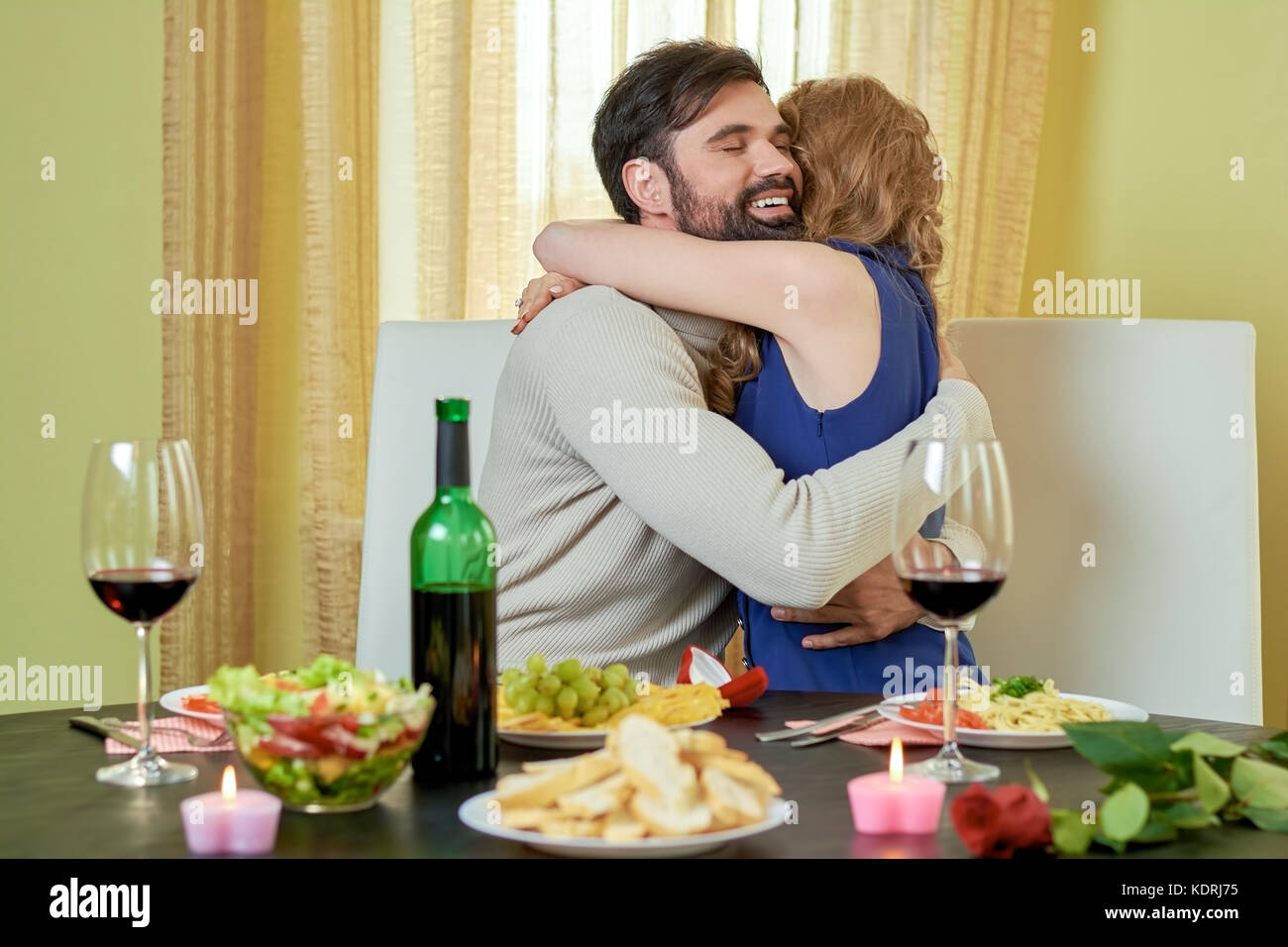 Young man hugging woman Stock Photo - Alamy