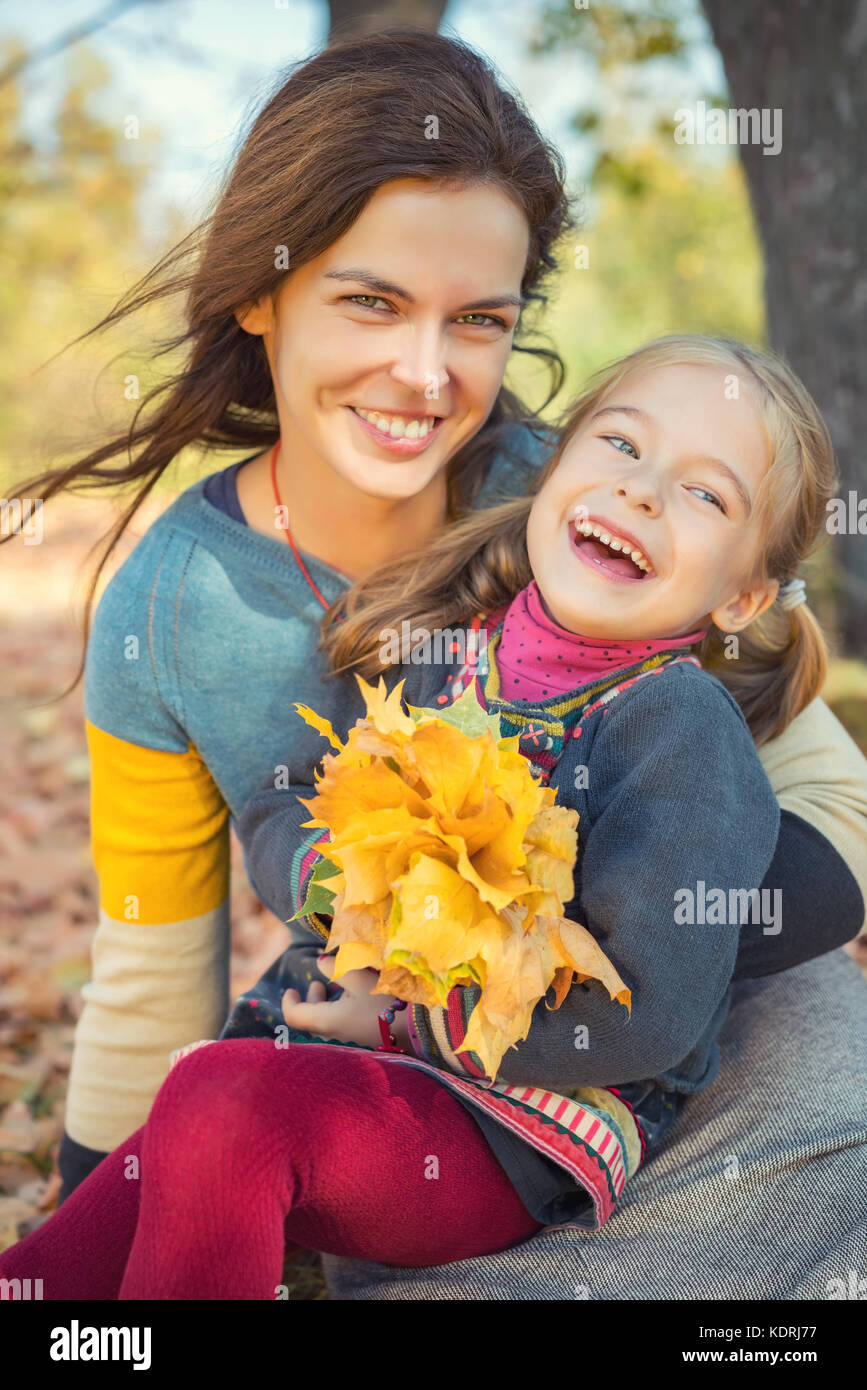 Mother and daughter playing in autumn park Stock Photo - Alamy