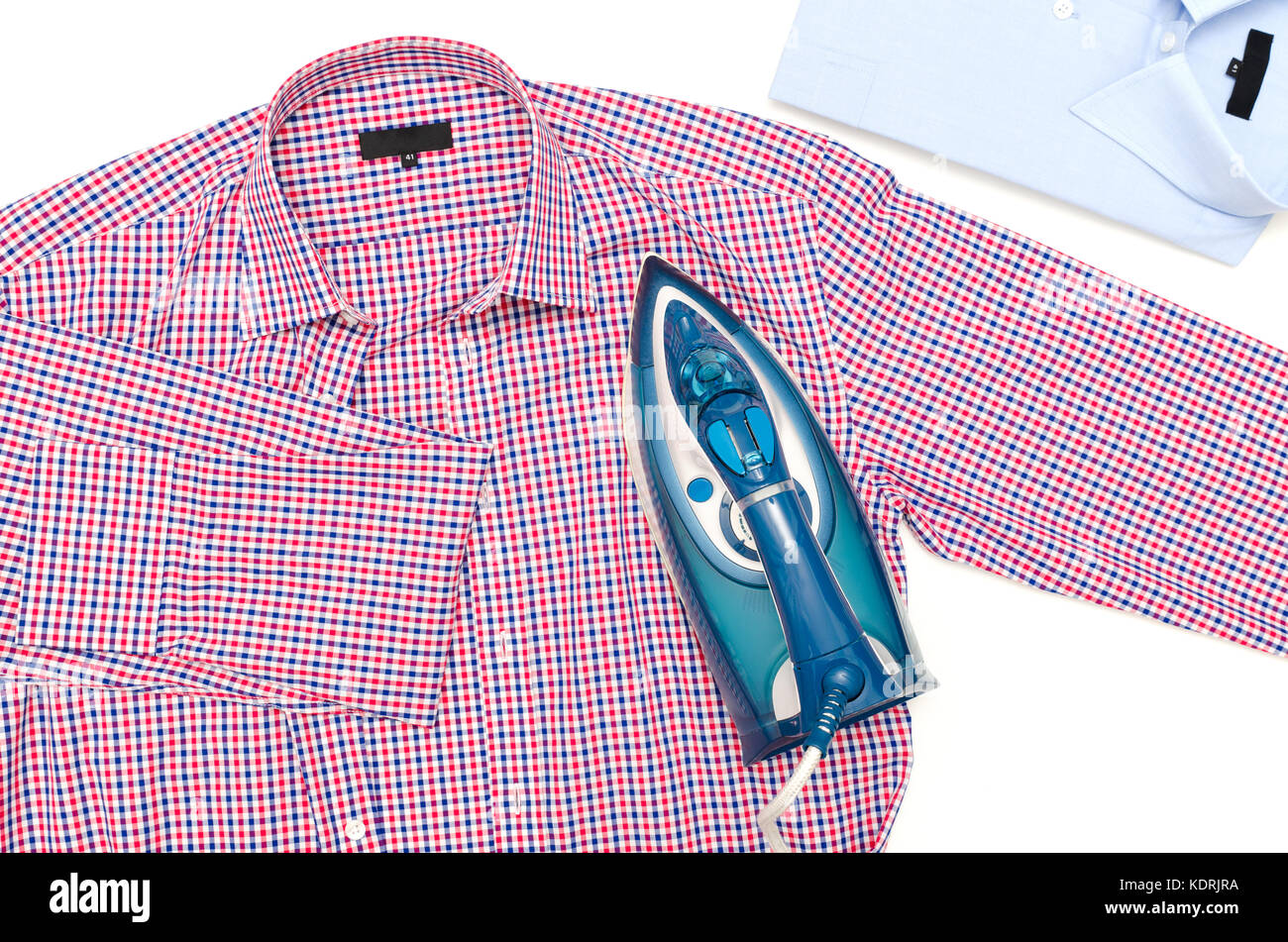 Female hand ironing men's shirt. Blue iron on white background top view