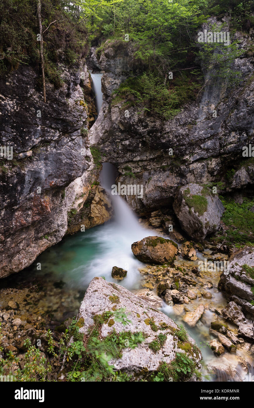 Beautiful Nemclja waterfall below a natural bridge in Soca valley