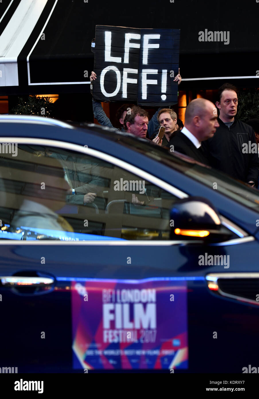 A protester with a sign reading 'LFF OFF!' in the crowd at the premiere of Three Billboards Outside Ebbing, Missouri at the closing gala of the BFI London Film Festival, at the Odeon Leicester Square, London. Stock Photo