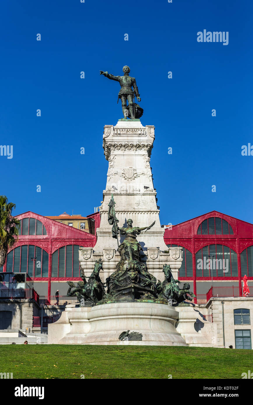 Infante D. Henrique (Prince Henry the Navigator) statue in Porto city in Portugal. Hard Club (formerly Ferreira Borges Market) on background Stock Photo