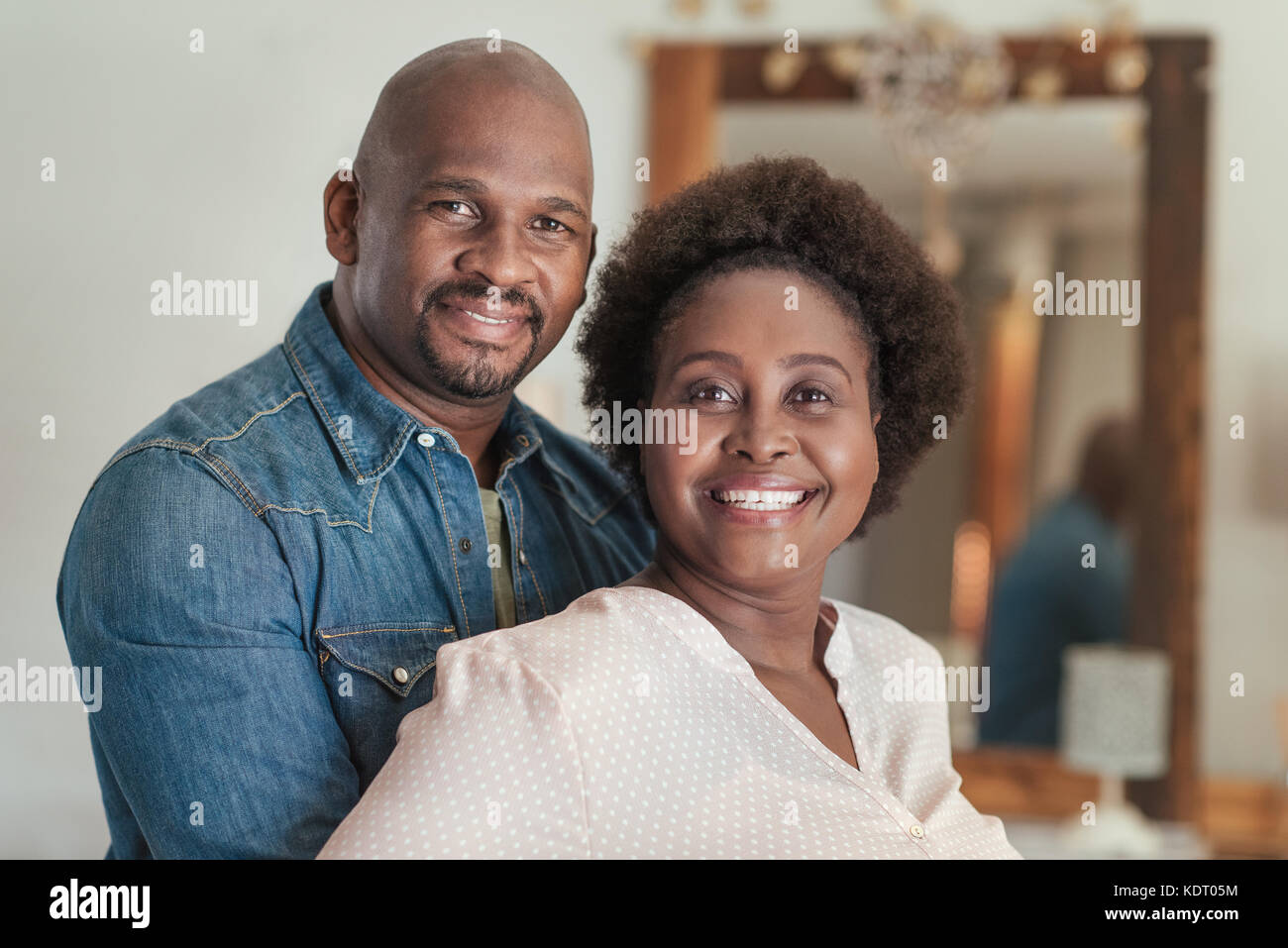 Content African couple smiling while standing together at home Stock ...