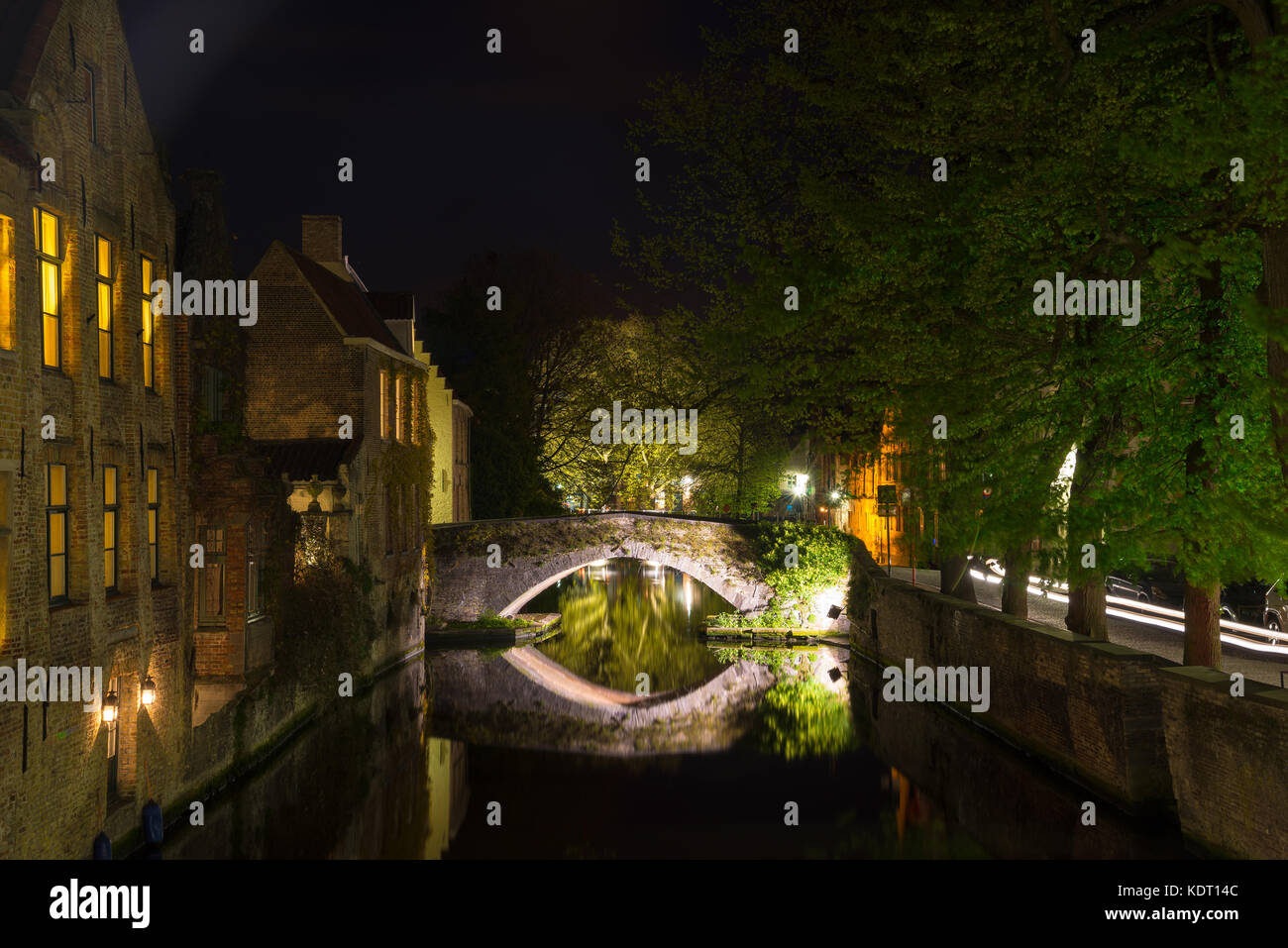 Bruges, Belgium - April 17, 2017: Night shot of historic medieval buildings along a canal in Bruges, Belgium Stock Photo
