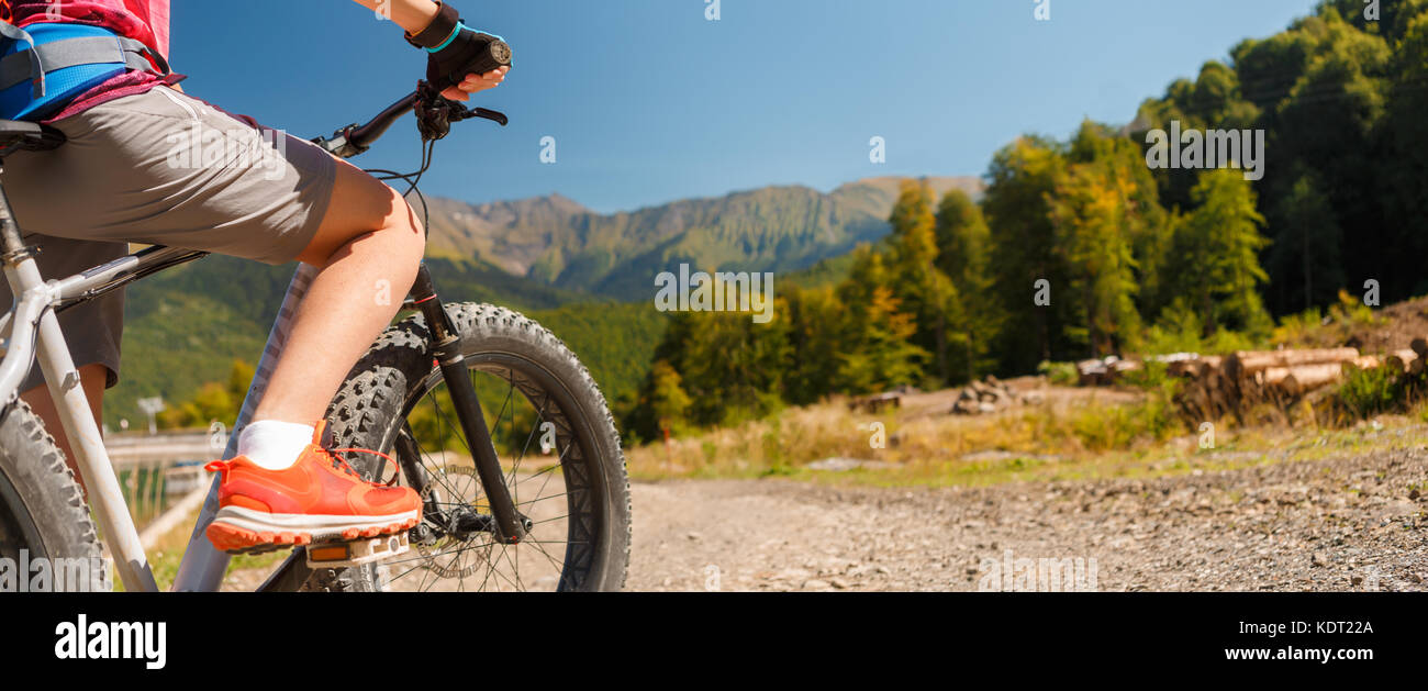 Image of girl in sneakers on bicycle Stock Photo