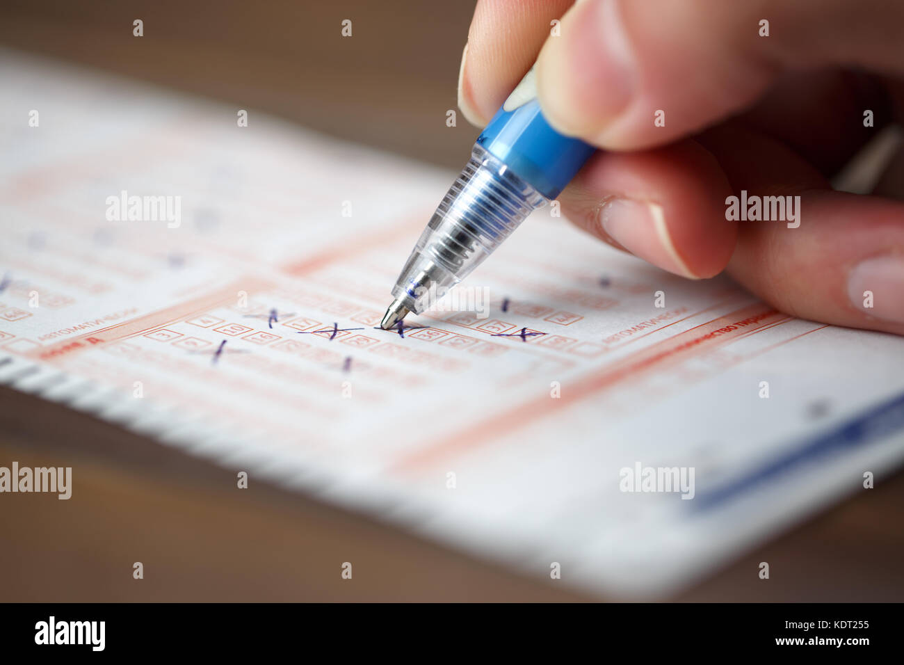 Image of person marking in lottery ticket Stock Photo